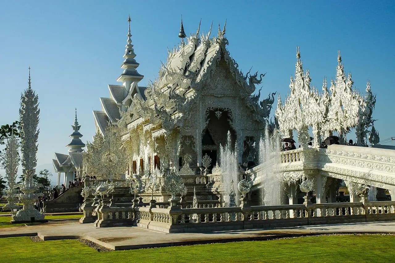 Golden Buddhist temple with traditional Lanna architecture surrounded by ancient city walls