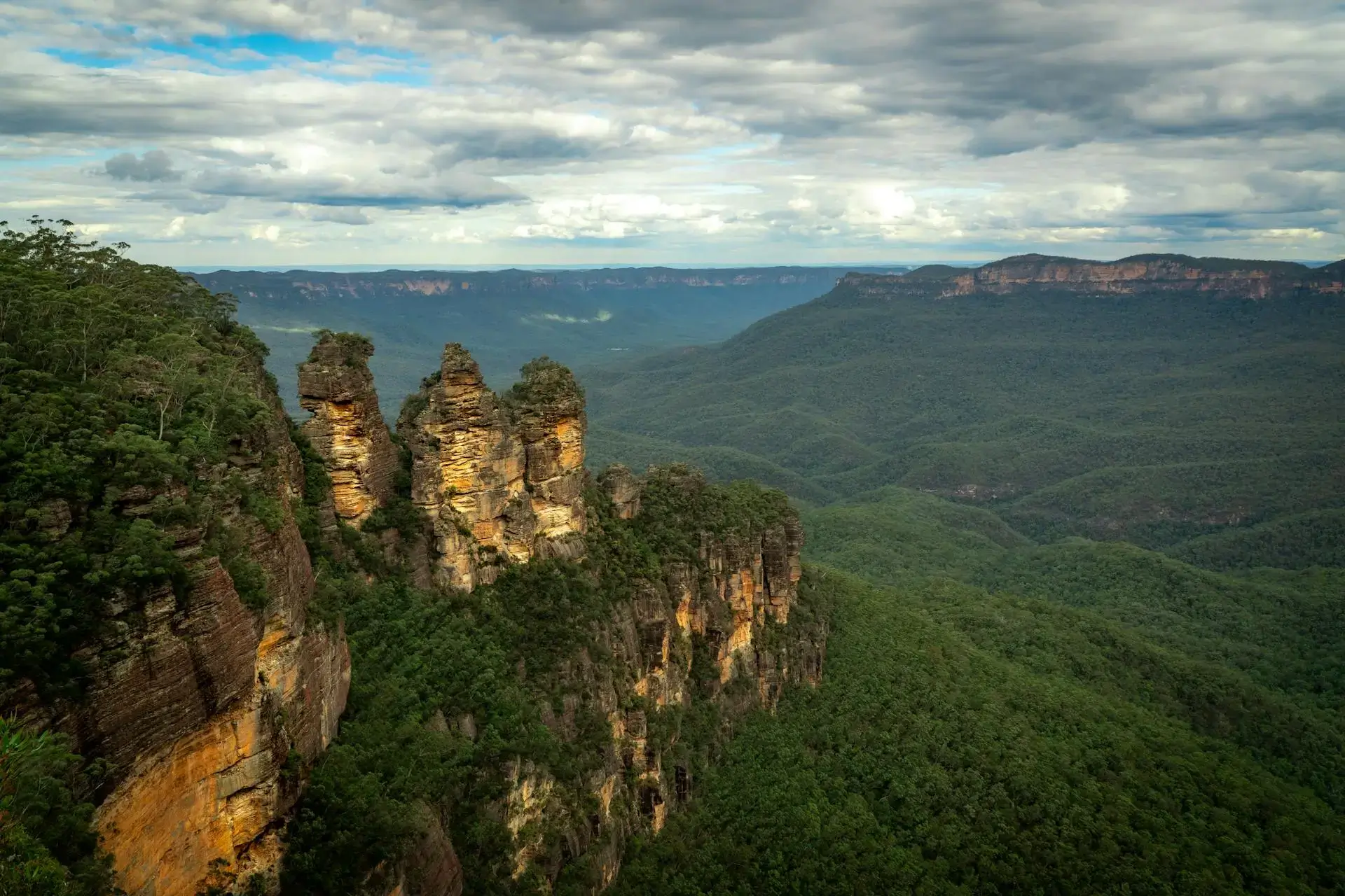 Three Sisters rock formation with misty blue eucalyptus forest valleys below
