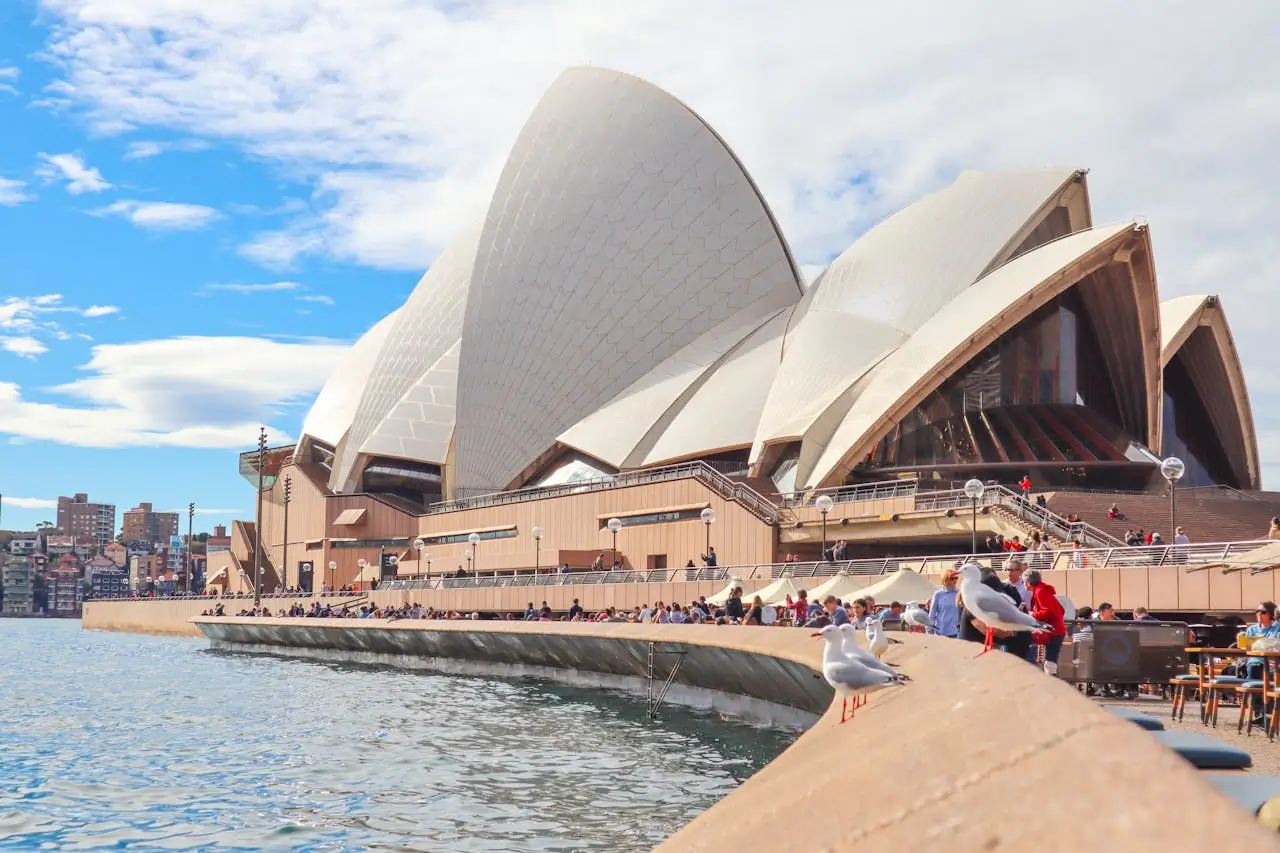Sydney Opera House with harbour bridge in background at sunset
