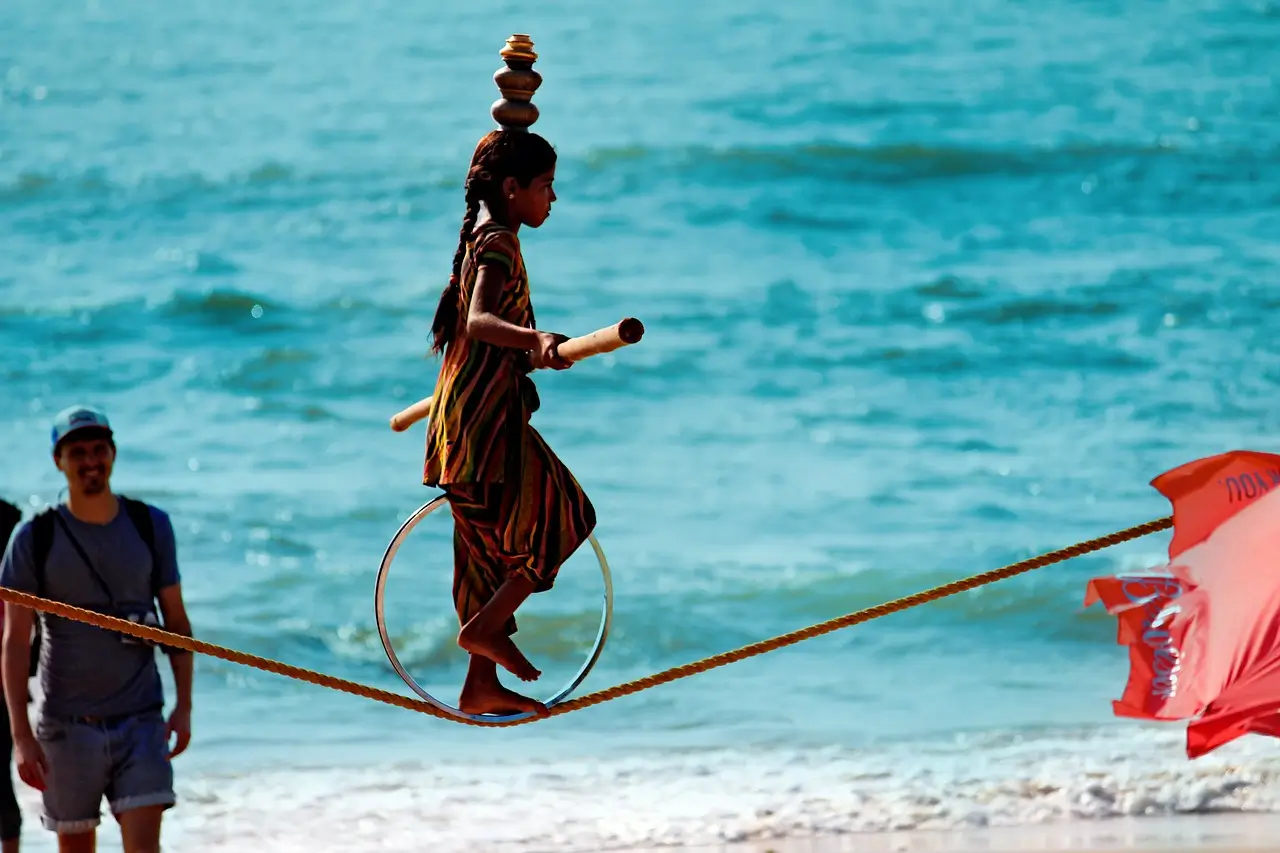 Golden sand beach in Goa with palm trees and fishing boats