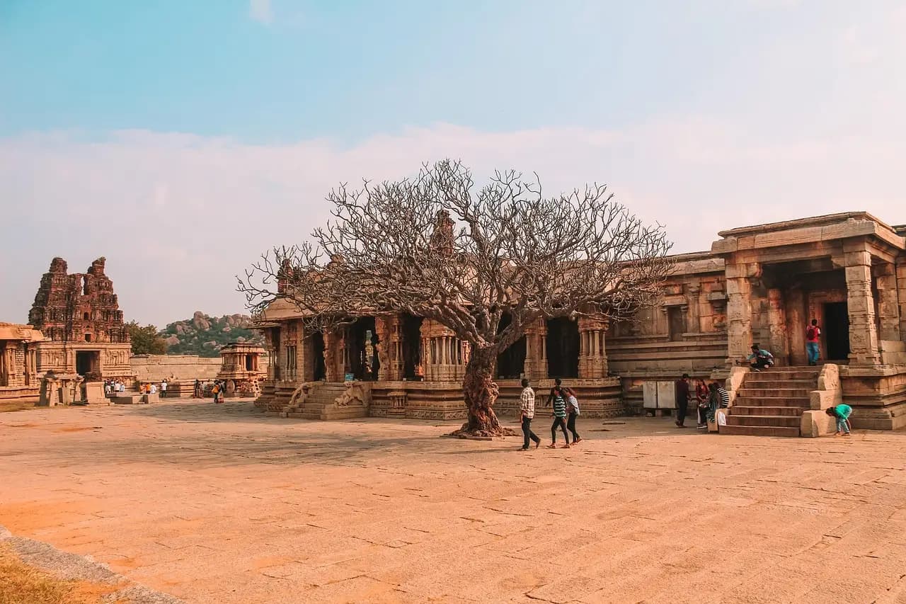 Ancient temple ruins among giant boulders in Hampi landscape