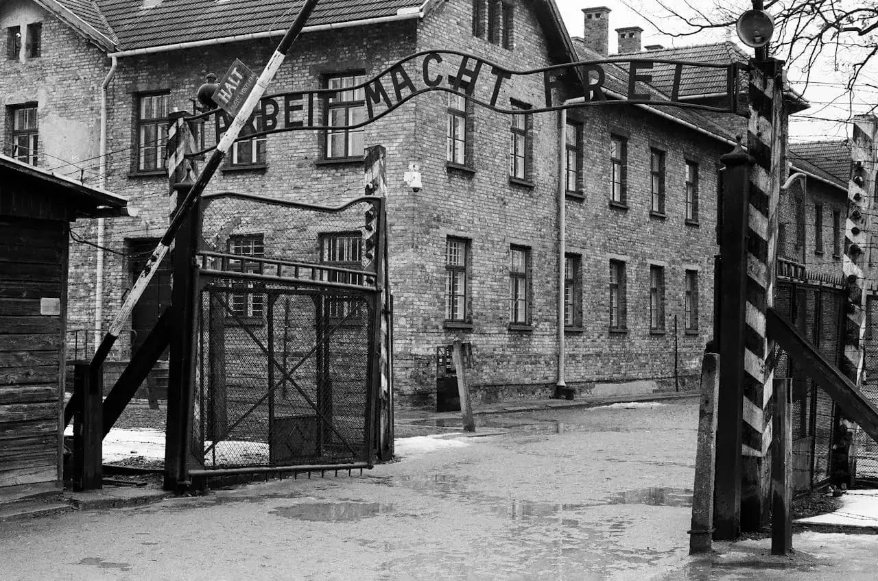 Entrance gate of Auschwitz concentration camp with railway tracks