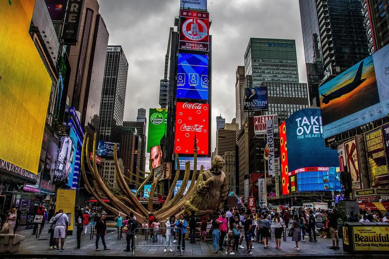 Times Square with colorful billboards and crowds at night